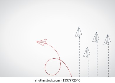 Think differently concept. Red airplane changing direction. New idea, change, trend, courage, creative solution, innovation and unique way concept.