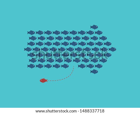Think differently -One red unique different fish swimming opposite way of identical blue ones.  