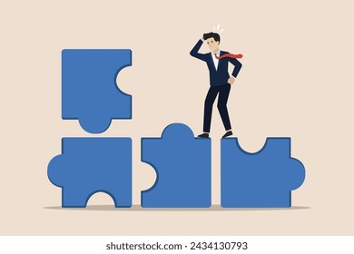 Thinking to find a solution, a challenge to complete a job or a business leadership mission, confused businessman putting together a puzzle.