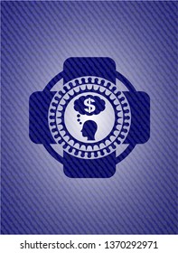 thinking in money icon inside badge with denim texture
