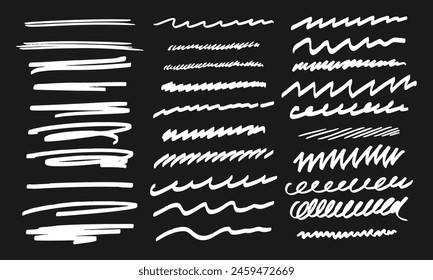 Thirty handwritten doodles. Collection of randomly drawn white squiggles on a black background