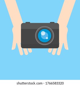 This is a camera in hands. Cartoon illustration.