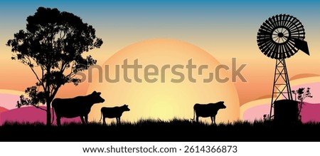 This captivating image showcases silhouettes of cows grazing in a serene landscape, framed by a vibrant sunset and a rustic windmill in the background. Outback Australia