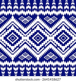 This dark blue and white native fabric print features prominent zigzag and intricate diamond geometric patterns, reflecting beautiful and unique tribal textile artistry.