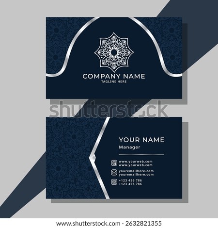 This elegant dark blue business card template features a sophisticated silver mandala on the front side and a sleek layout for contact details on the back.