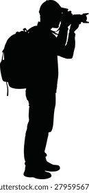 This image depicts a photographer with a camera and backpack presented as a solid black silhouette against a white background.