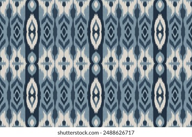 This image features a traditional ikat pattern rendered in various shades of blue, creating a striking and intricate design. The symmetrical layout showcases the classic blurred edges typical of the i