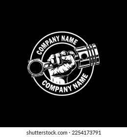 Das ist ein Logo, das eine Hand hält, die einen Kolben hält