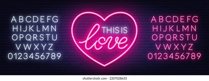 This is Love neon sign in heart shaped frame on brick wall background.