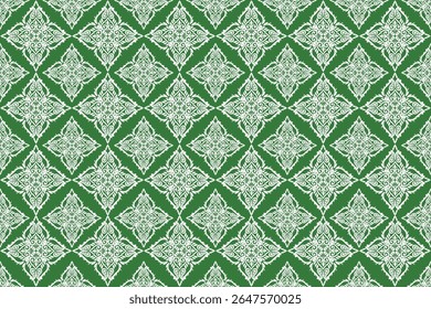 This pattern features intricate white floral motifs arranged in diamond shapes on a green background, showcasing traditional Thai-inspired elegance and symmetrical detailing.