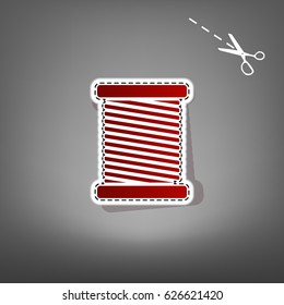 Thread sign illustration. Vector. Red icon with for applique from paper with shadow on gray background with scissors.
