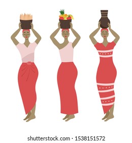 Three African women in different dresses hold tapioca roots, fruit and a jug on their heads. Vector on white background