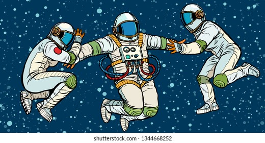 three astronauts in space in zero gravity. Pop art retro vector illustration kitsch vintage