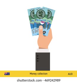 Three Australian dollar in hand. Australian dollar banknote.