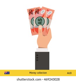 Three Australian dollar in hand. Australian dollar banknote.