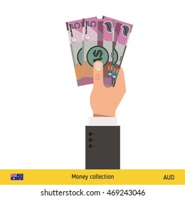 Three Australian dollar in hand. Australian dollar banknote.