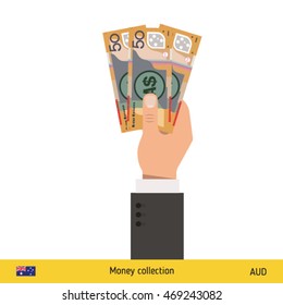 Three Australian dollar in hand. Australian dollar banknote.