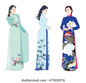 Three beautiful young women wearing traditional costumes of Vietnam, floral aodai long dresses. Isolated on white background.