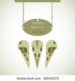 Three bird skulls sign with a plaque hanging on chains
