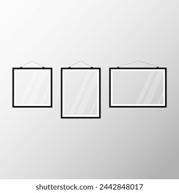 Three black white picture frames hanging on the wall