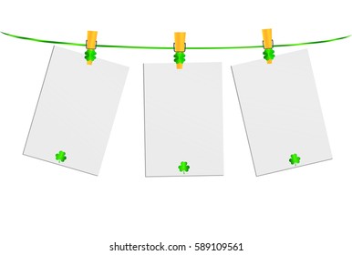 Three blank pages of paper with green clovers hanging on a rope on a wooden clothespin. St.Patrick 's Day. Free space for your letters or advertising. Greeting card. Vector 