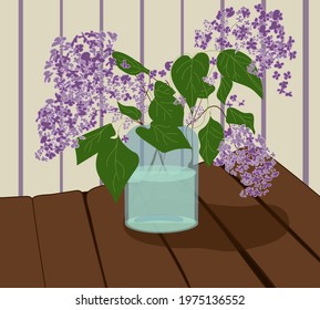 Three branches of spring lilacs in a jar with water