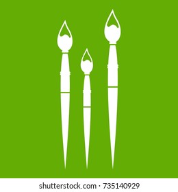 Three brushes for painting icon white isolated on green background. Vector illustration