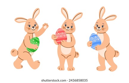 Three bunny in different poses hold painted Easter eggs of different colors in their paws. Cute baby vector greeting illustration on white isolated background in cartoon style.