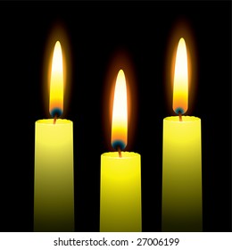 Three burning candles with yellow wax and outer glow