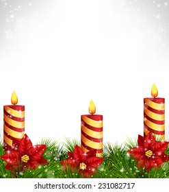 Three burning Christmas candles with pine branches and flowers of poinsettia in snowfall on grayscale background