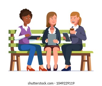 Three Business Woman Sitting On A Bench Together With Their Gadgets Talking Having A Break. Coworkers Relaxing Chatting And Tapping Tablet Computers. Flat Style Isolated Vector Character Illustration