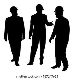 Three businessmen architects engineers or workers with a protective helmet walking and talking about new project.