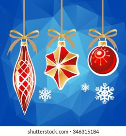 Three Christmas toys on a blue polygonal background.