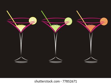 Three cocktails in martini glasses isolated on a black background