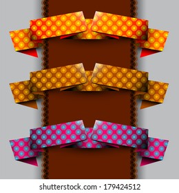 Three color ribbons with circles pattern on the brown tape and gray background