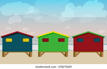Three Colorful Flat bungalow-houses on the beach with the sky and clouds.