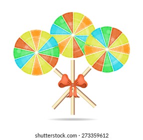 Three colorful, round, isolated lollipops with red bow and pattern, white background