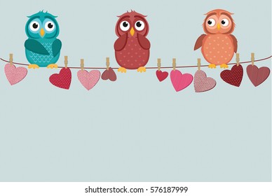 three cute colored owlet sitting on a string. A red hearts with a picture hanging on a rope.  Valentine's Day. Vector illustration. Greeting card with empty space for the label or advertising. 