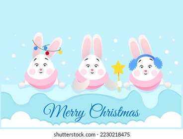 Three cute rabbits peek out of the snow and wish you a Merry Christmas