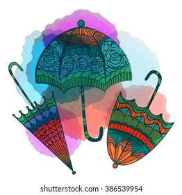 Three decorative umbrella with beautiful ornament on the background of watercolor spots on a white background