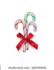 Three different color striped candy canes with red bow isolated on white background. Vector Christmas and New Year design element