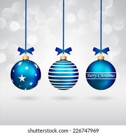 Three different decorated christmas balls with bows on sparkling background.