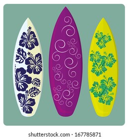 three different surfboards with different colors and styles