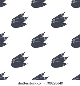 three eggplants are laid out in a pattern