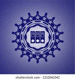 three folders icon inside emblem with denim texture