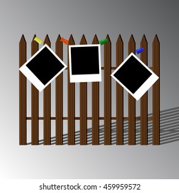 Three frames for photos on the background of wooden fence with shadow
