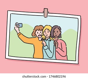 Three friends are taking selfies together. Photo frame concept. hand drawn style vector design illustrations. 