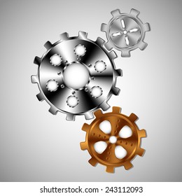 Three gears of different sizes and colors on a light background.