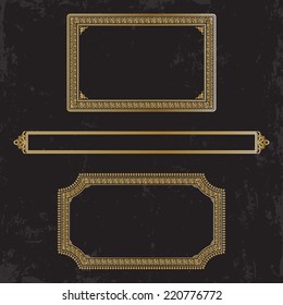 Three gilt decorated frames on a dark shabby background