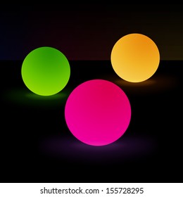 Three glowing light orbs isolated on dark background